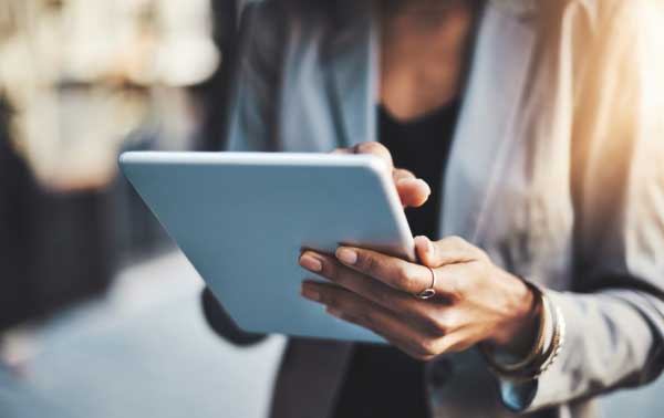 Professional using a tablet for digital learning and online training